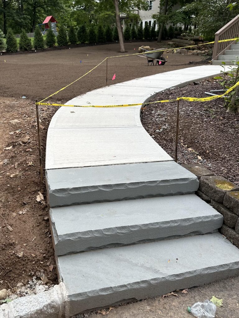 Our Concrete Walkway With Bluestone Steps Installation Elevates Curb Appeal in Berkeley Heights, NJ - Sage Landscaping